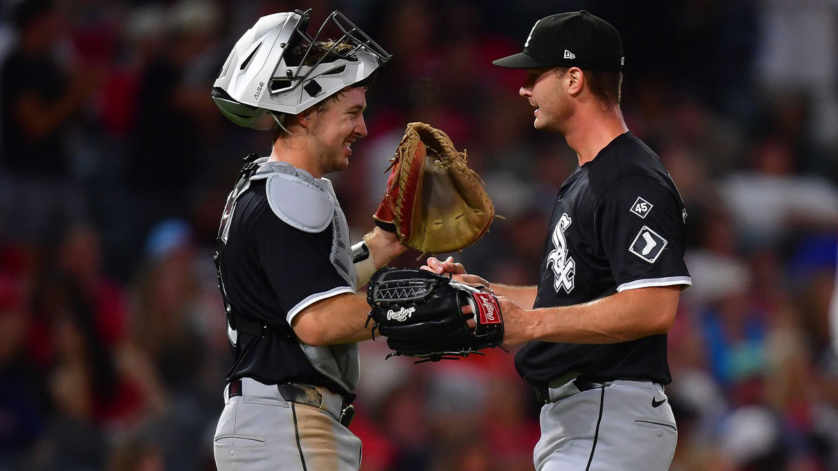 White Sox catcher Kyle Teel (8) and pitcher Jordan Leasure (49) celebrate