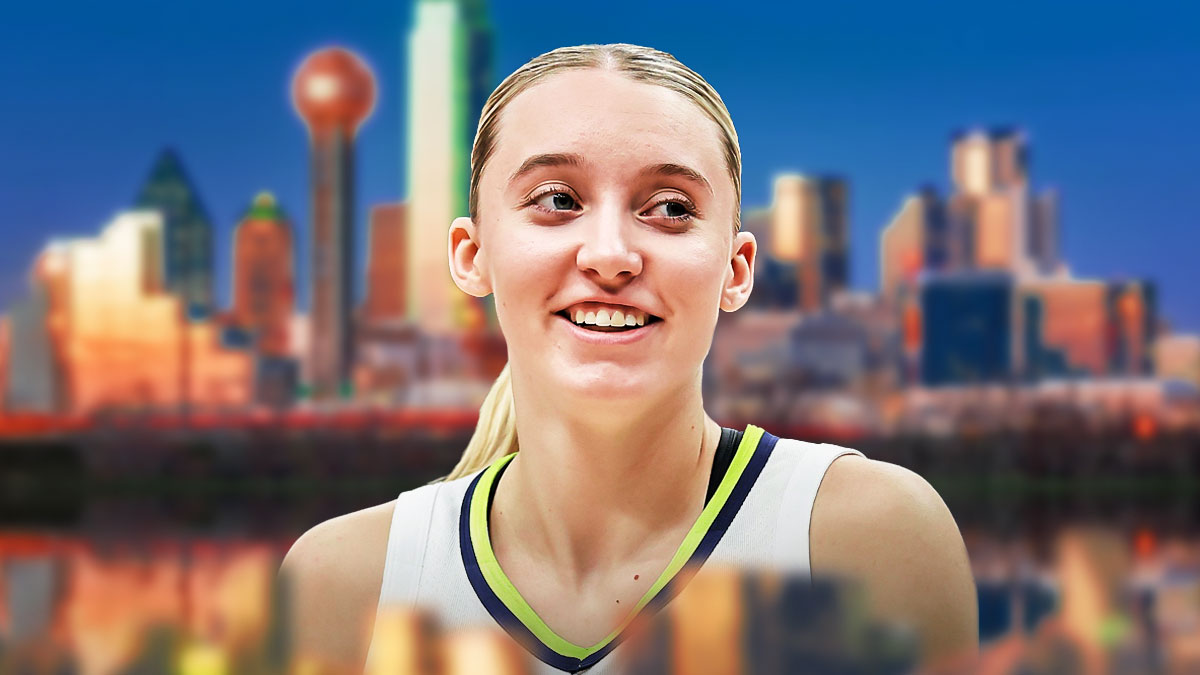Wings Paige Bueckers smiling with the Dallas city skyline in background.