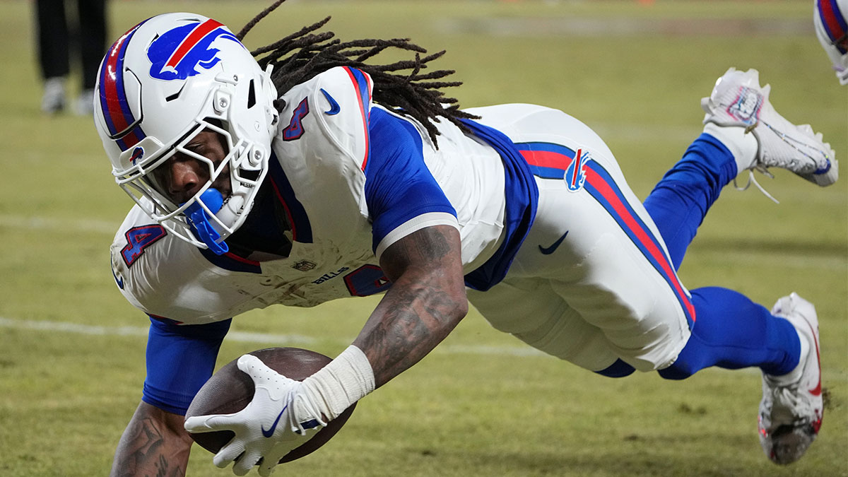 Buffalo Bills running back James Cook (4) dives for a touchdown against the Kansas City Chiefs in the AFC Championship game at GEHA Field at Arrowhead Stadium.
