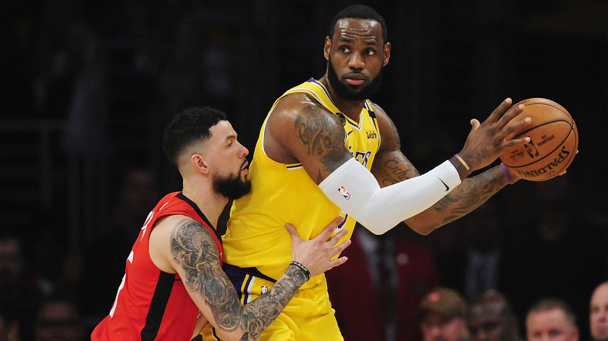 Los Angeles Lakers forward LeBron James (23) controls the ball against Houston Rockets guard Austin Rivers (25) during the first half at Staples Center.
