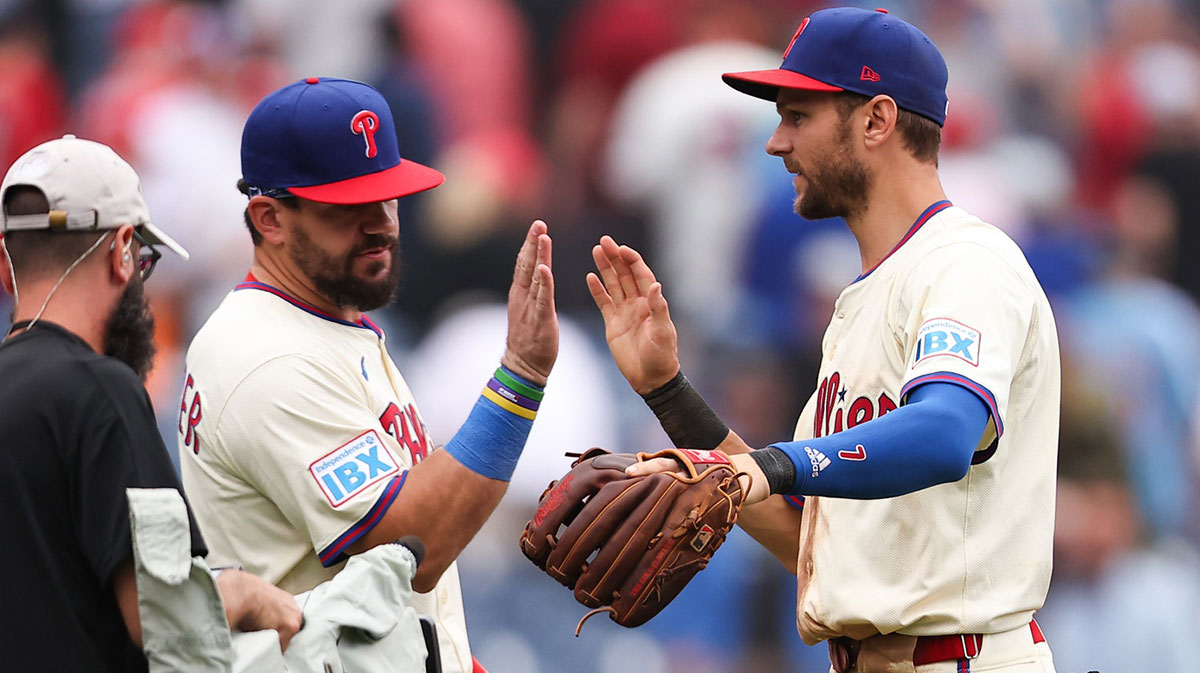 Philadelphia Phillies designated hitter Kyle Schwarber (12) and shortstop Trea Turner (7) high five after a victory against the Seattle Mariners at Citizens Bank Park. Mandatory Credit: Bill Streicher-Imagn Images