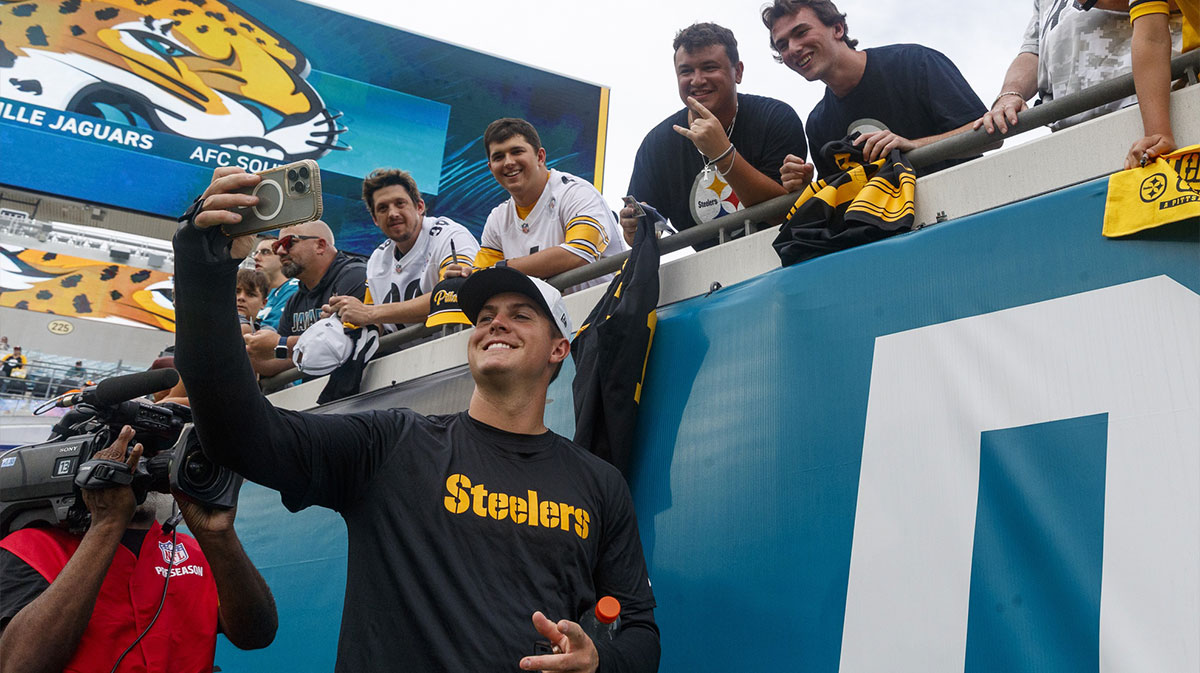 Pittsburgh Steelers quarterback Will Howard (18) takes a selfie with a fan before the game against the Jacksonville Jaguars at EverBank Stadium.