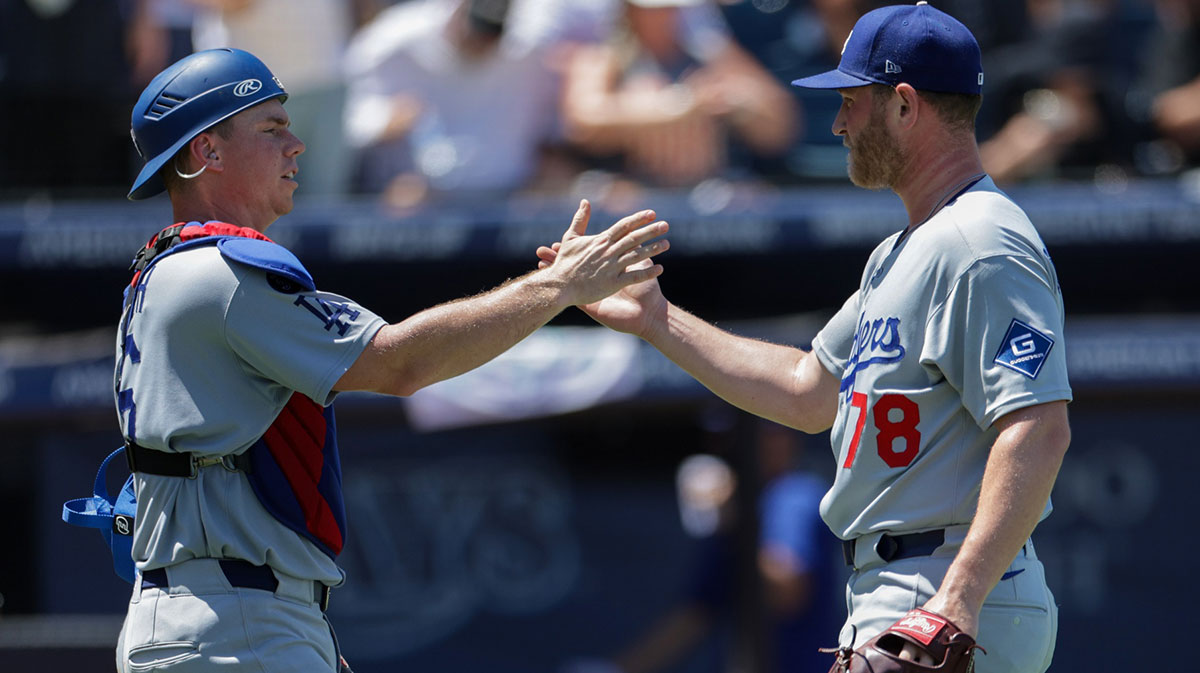 Los Angeles Dodgers catcher Will Smith (16) and pitcher Ben Casparius (78) react after beating the Tampa Bay Rays at George M. Steinbrenner Field.