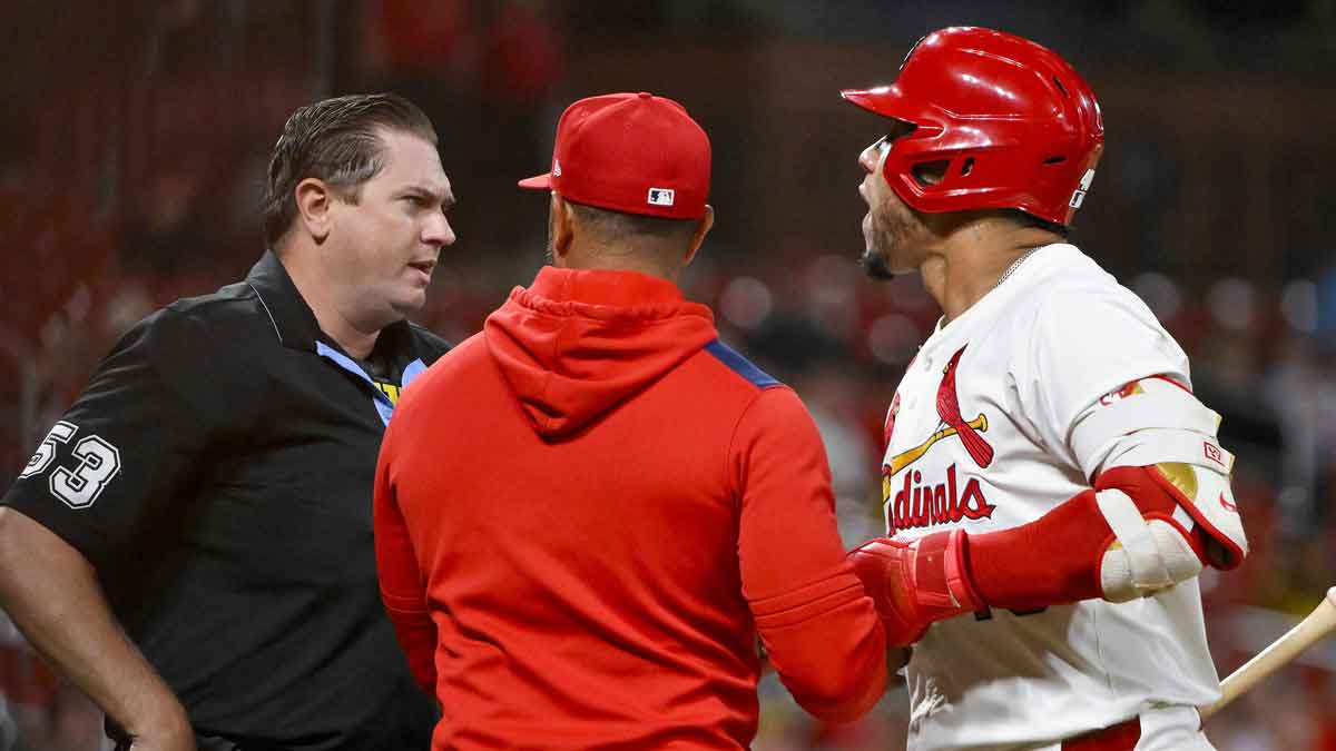 St. Louis Cardinals designated hitter Willson Contreras (40) is held back by manager Oliver Marmol (37) after he was ejected by umpire Derek Thomas (53) during the seventh inning against the Pittsburgh Pirates at Busch Stadium.