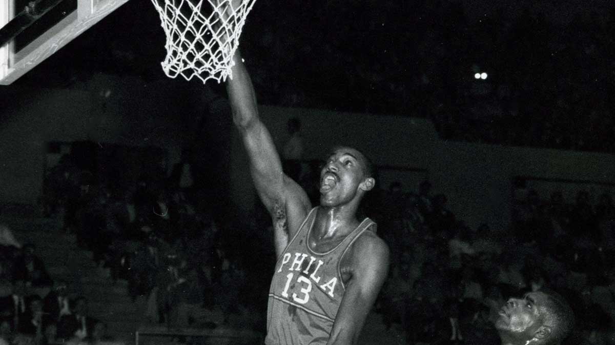 Philadelphia Warriors center Wilt Chamberlain (13) dunks the ball against the Los Angeles Lakers at the Los Angeles Sports Arena.