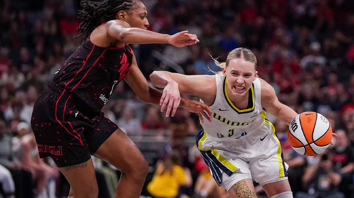 Indiana Fever guard Kelsey Mitchell (0) rushes up the court against Dallas Wings guard Paige Bueckers (5) on Tuesday, Aug. 12, 2025, during the game at Gainbridge Fieldhouse
