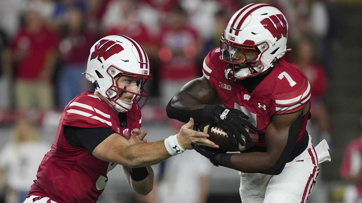 Wisconsin Badgers quarterback Billy Edwards Jr. (9) hands the football off to running back Dilin Jones (7) during the first quarter against the Miami (OH) RedHawks at Camp Randall Stadium.