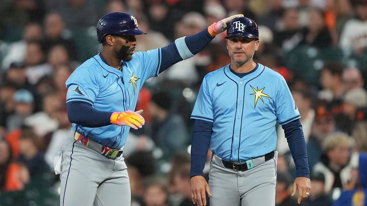 Tampa Bay Rays designated hitter Yandy Diaz (left) celebrates with first base coach Michael Johns (right) after hitting an RBI-single against the San Francisco Giants during the eighth inning at Oracle Park.