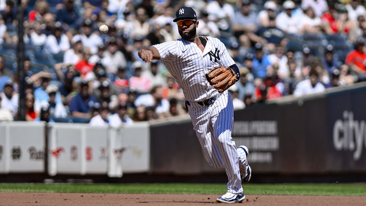 Aug 23, 2025; Bronx, New York, USA; New York Yankees third baseman Amed Rosario (14) fields a ground ball hit by Boston Red Sox third baseman Alex Bregman (not pictured) and throws to first base for an out during the first inning at Yankee Stadium. Mandatory Credit: John Jones-Imagn Images
