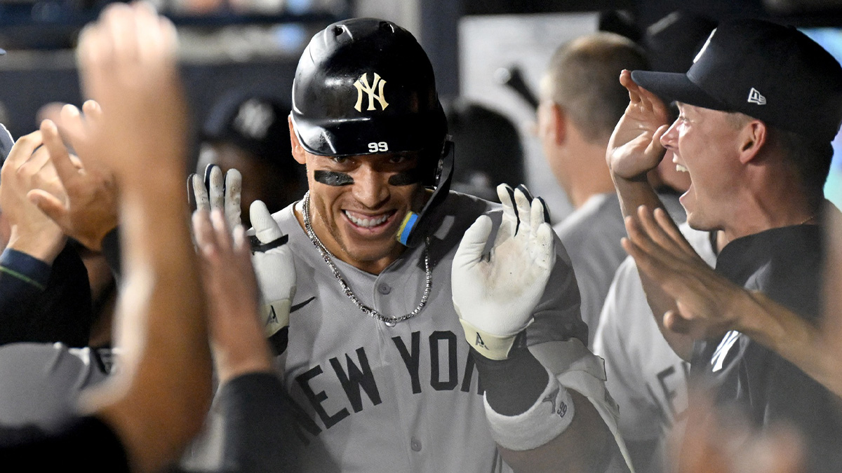 New York Yankees designated hitter Aaron Judge (99) celebrates in the dugout after hitting a solo home run in the first inning against the Tampa Bay Rays at George M. Steinbrenner Field.
