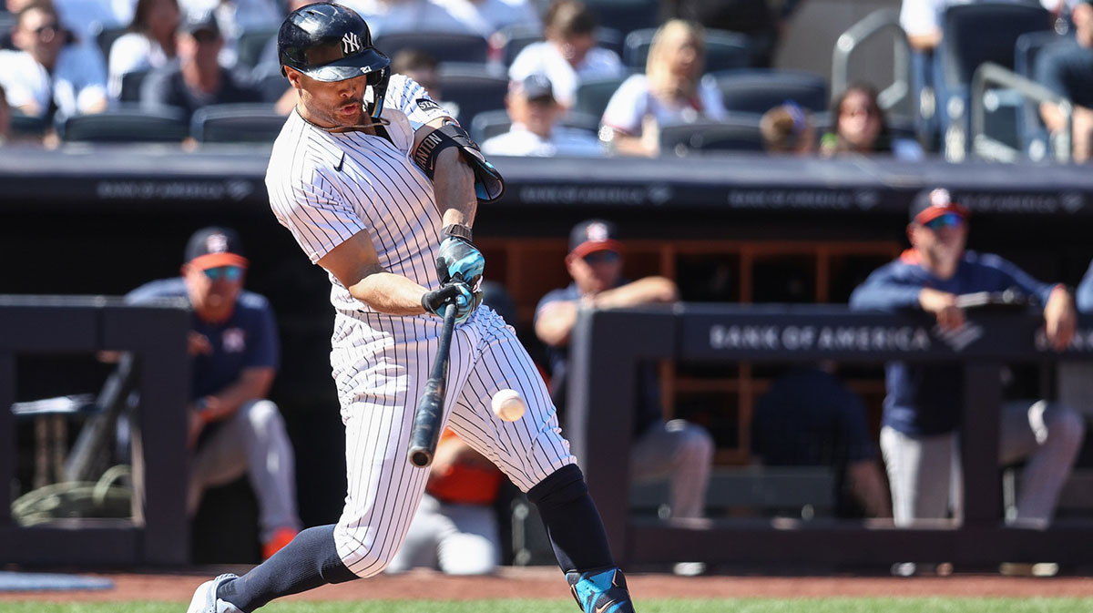 New York Yankees right fielder Giancarlo Stanton (27) hits an RBI single in the fifth inning against the Houston Astros at Yankee Stadium.