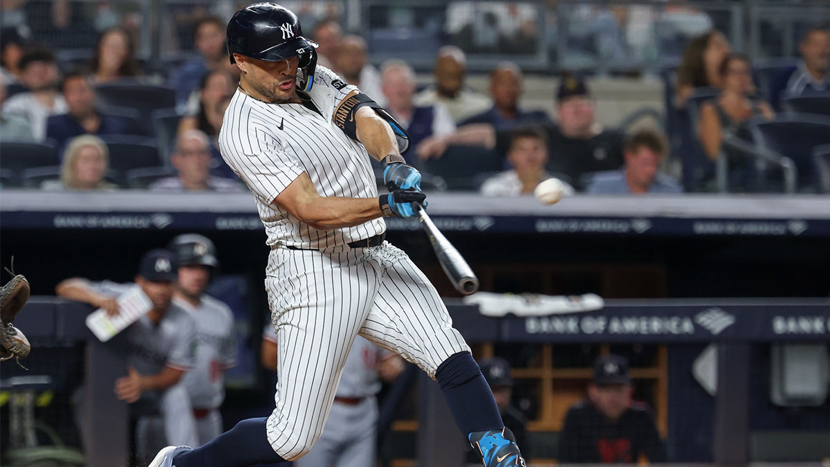 New York Yankees right fielder Giancarlo Stanton (27) hits a solo home run during the fifth inning against the Minnesota Twins at Yankee Stadium.