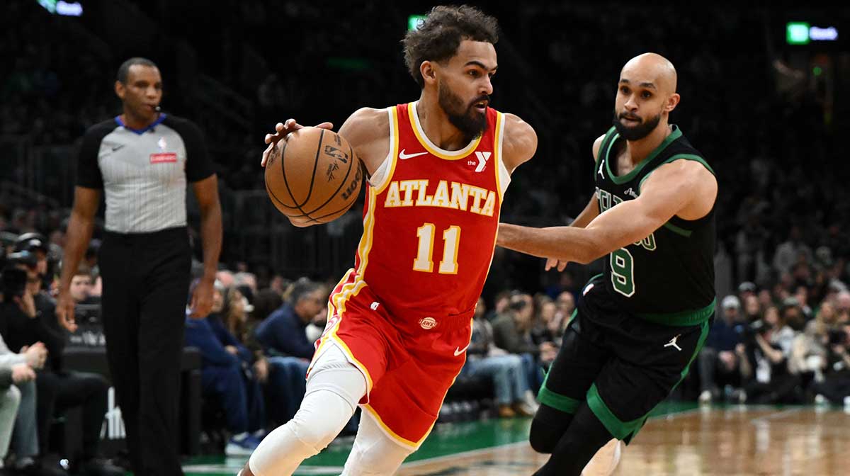 Atlanta Hawks guard Trae Young (11) drives to the basket against Boston Celtics guard Derrick White (9) during the first quarter at the TD Garden.
