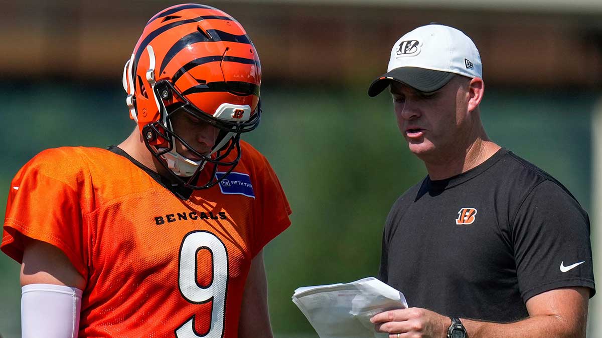 Cincinnati Bengals quarterback Joe Burrow (9) talks with head coach Zac Taylor during a preseason training camp practice in downtown Cincinnati on Wednesday, July 30, 2025.