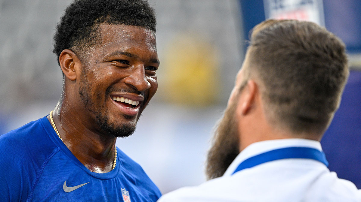 New York Giants quarterback Jameis Winston (19) greets retired NFL player Ryan Fitzpatrick before the game against the New England Patriots at MetLife Stadium.