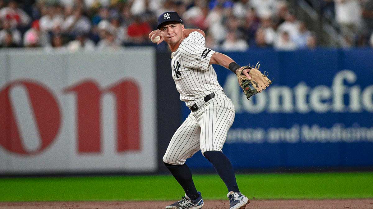 New York Yankees shortstop Anthony Volpe (11) fields a ground ball hit by third baseman Alex Bregman (2) and throws to first for an out during the eighth inning at Yankee Stadium.