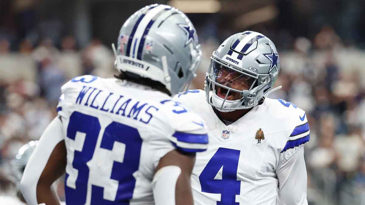 Dallas Cowboys running back Javonte Williams (33) celebrates with quarterback Dak Prescott (4) after scoring a touchdown against the New York Giants during the third quarter at AT&T Stadium.