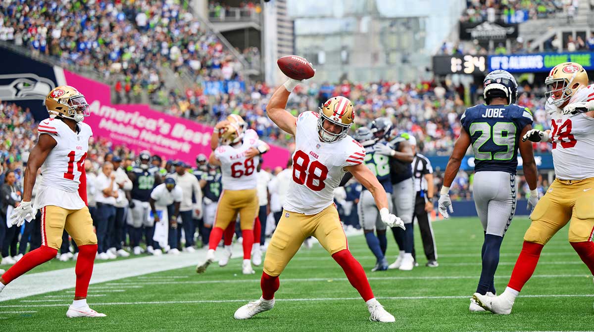 San Francisco 49ers tight end Jake Tonges (88) celebrates after scoring a touchdown against Seattle Seahawks cornerback Riq Woolen (27) during the second half at Lumen Field.