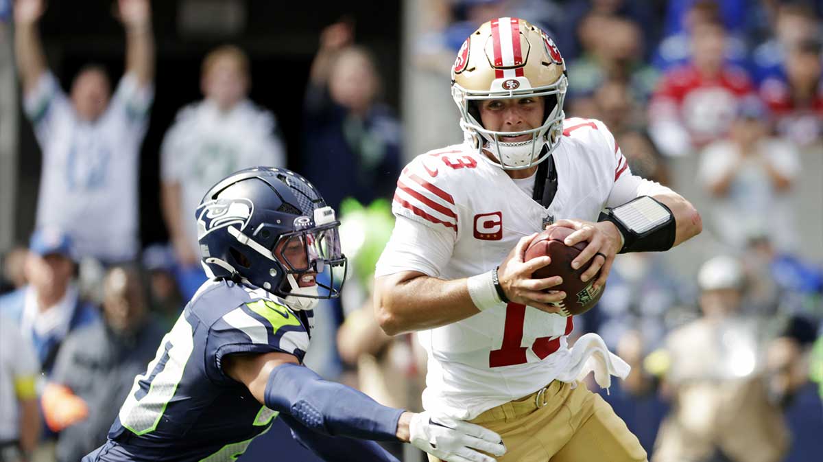 San Francisco 49ers quarterback Brock Purdy (13) runs the ball during the first half against the Seattle Seahawks at Lumen Field.