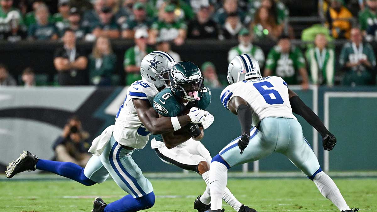Philadelphia Eagles wide receiver DeVonta Smith (6) is tackled by Dallas Cowboys linebacker Kenneth Murray Jr. (59) and safety Donovan Wilson (6) during the second quarter of the game at Lincoln Financial Field.