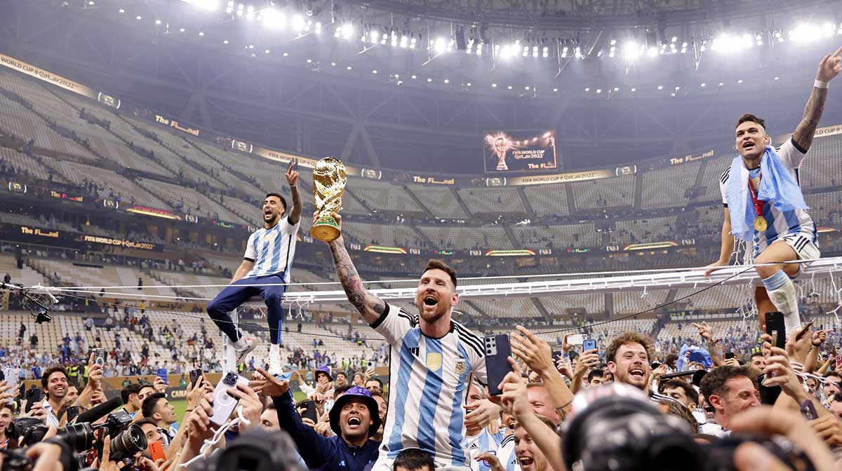 Argentina forward Lionel Messi (10) celebrates with fans after winning the 2022 World Cup final against France at Lusail Stadium.