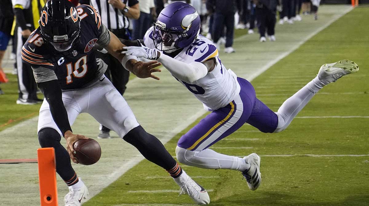 Chicago Bears quarterback Caleb Williams (18) rushes the ball past Minnesota Vikings safety Theo Jackson (26) during the second half at Soldier Field.