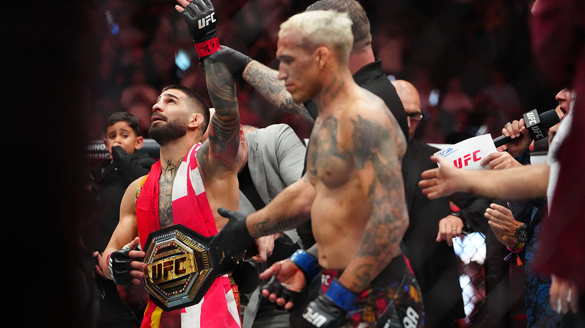 Ilia Topuria (red gloves) reacts after the fight against Charles Oliveira (blue gloves) during UFC 317 at T-Mobile Arena.
