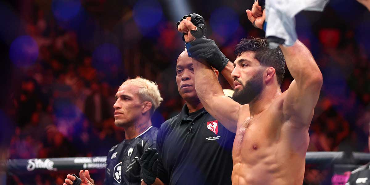 Arman Tsarukyan (blue gloves) reacts after defeating Charles Oliveira (red gloves) during UFC 300 at T-Mobile Arena.