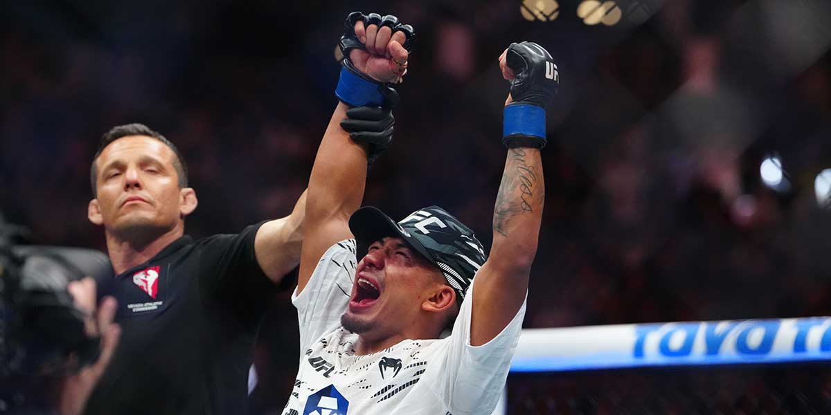 Joshua Van (blue gloves) reacts after the fight against Brandon Royval (red gloves) during UFC 317 at T-Mobile Arena.