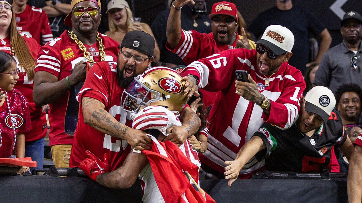 San Francisco 49ers wide receiver Jauan Jennings (15) leaps up to the fans after scoring a touchdown against the New Orleans Saints during the second half at Caesars Superdome.
