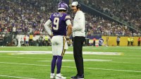 Minnesota Vikings quarterback JJ McCarthy (9) speaks with Minnesota Vikings head coach Kevin O'Connell during the first half against the Atlanta Falcons at U.S. Bank Stadium.