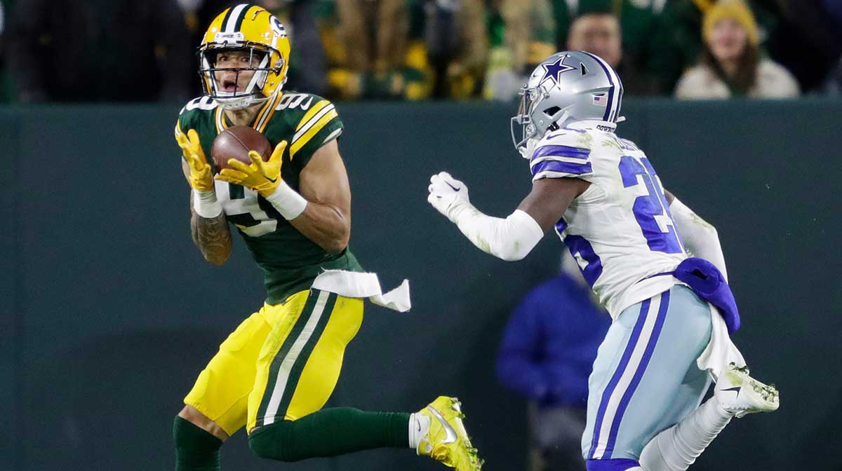 Green Bay Packers wide receiver Christian Watson (9) pulls down a touchdown reception against Dallas Cowboys cornerback DaRon Bland (26) in the fourth quarter during their football game Sunday, November 13, at Lambeau Field in Green Bay, Wis. 