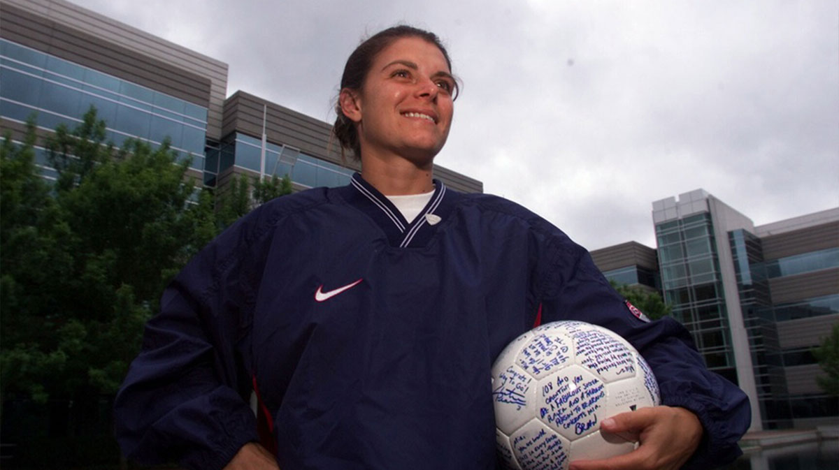 US soccer player Mia Hamm with a ball autographed by her teammates to commemorate the dedication of a building in her name at the Nike World Headquarters. 