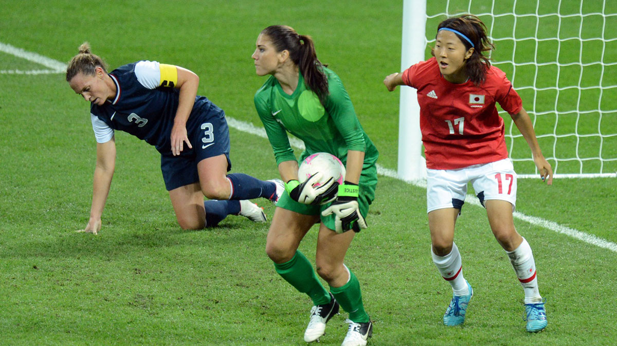 goalkeeper Hope Solo (1) picks up the ball as Japan forward Yuki Ogimi (17) looks on during the London 2012 Olympic Games at Wembley Stadium. 