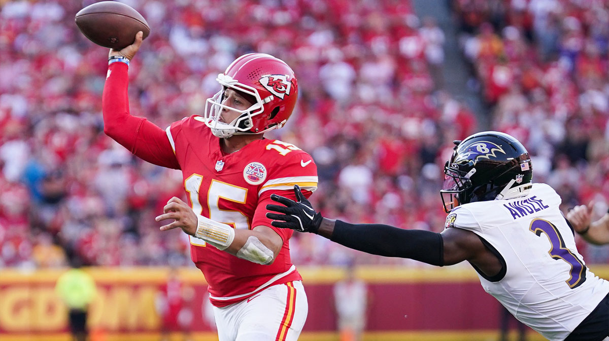 Kansas City Chiefs quarterback Patrick Mahomes (15) makes a pass as Baltimore Ravens cornerback Chidobe Awuzie (3) defends at GEHA Field at Arrowhead Stadium. 