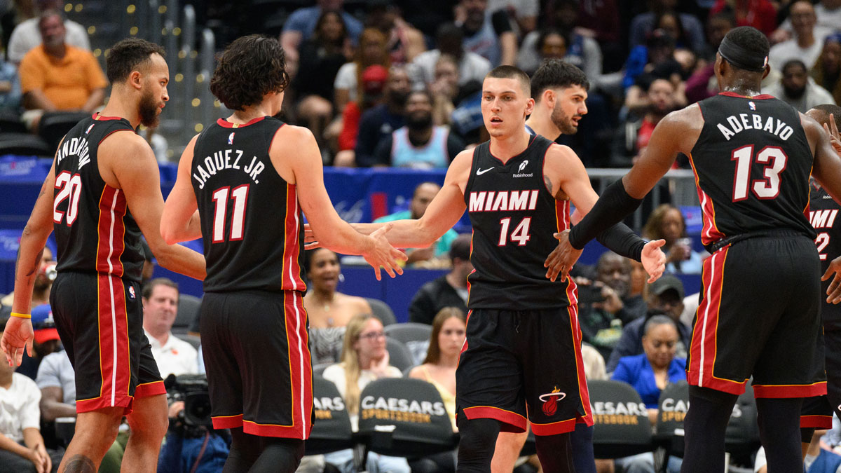 Miami Heat guard Tyler Herro (14) reacts with center Bam Adebayo (13), and guard Jaime Jaquez Jr. (11) during the third quarter against the Washington Wizards at Capital One Arena. 