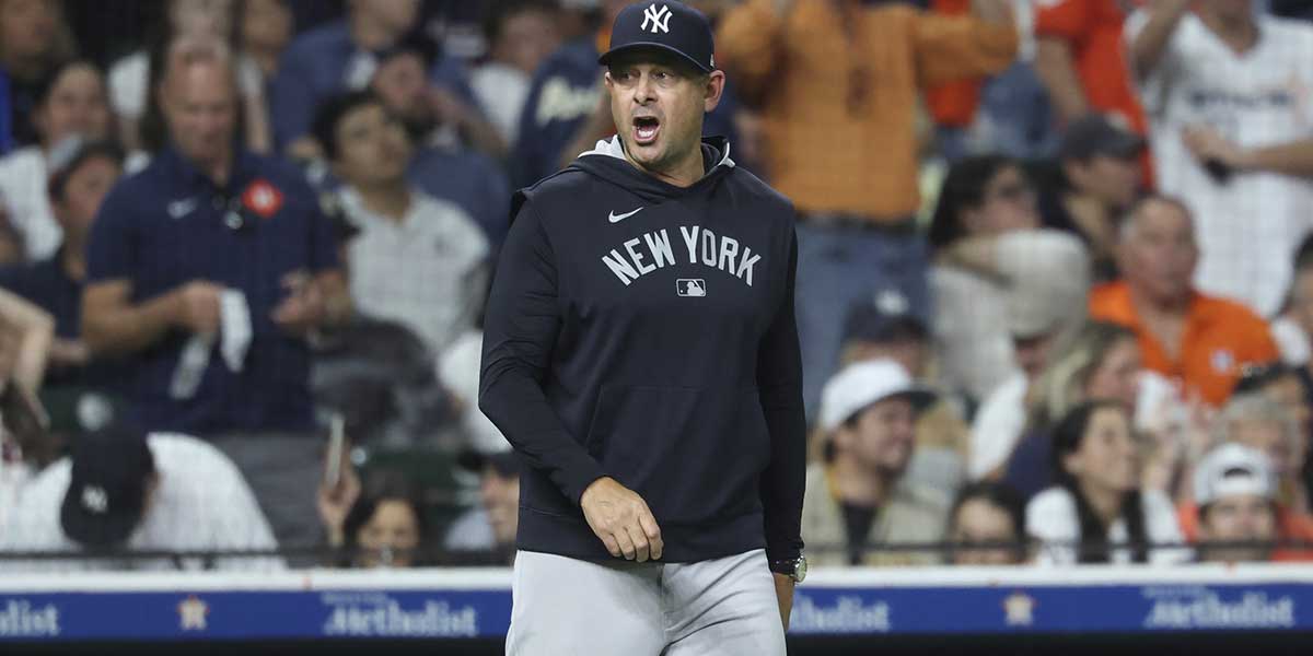 New York Yankees manager Aaron Boone looks towards home plate during a pitching change in the eighth inning against the Houston Astros at Daikin Park.