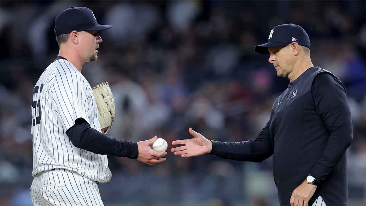 New York Yankees manager Aaron Boone (17) takes the ball from relief pitcher Mark Leiter Jr. (56) during a pitching change during the seventh inning against the Detroit Tigers at Yankee Stadium.
