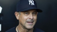 New York Yankees manager Aaron Boone (17) speaks before a baseball game against the Chicago White Sox at Rate Field.