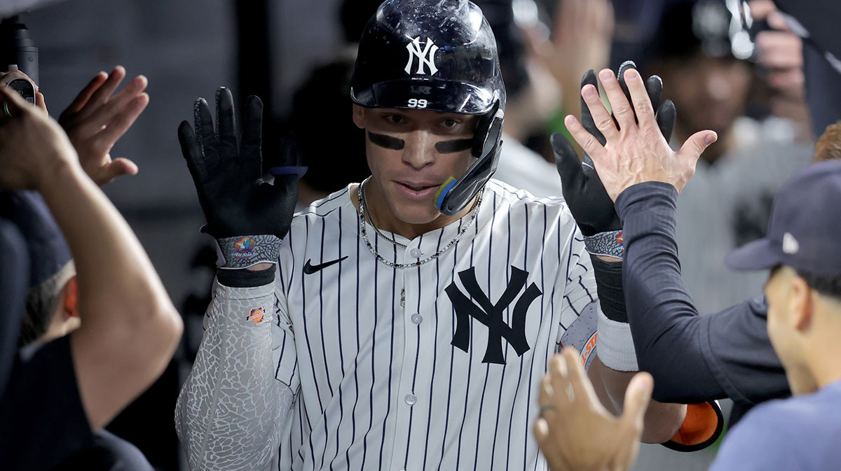 New York Yankees right fielder Aaron Judge (99) celebrates his two run home run against the Baltimore Orioles with teammates in the dugout during the third inning at Yankee Stadium.