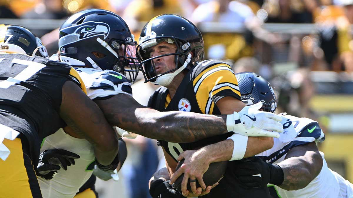 Seattle Seahawks defensive end Leonard Williams (99) and defensive tackle Byron Murphy II (91) sack Pittsburgh Steelers quarterback Aaron Rodgers (8) during the second quarter at Acrisure Stadium.