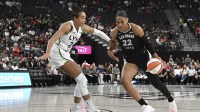 Las Vegas Aces center A'ja Wilson (22) drives past Minnesota Lynx forward Napheesa Collier (24) in the first quarter of their game at T-Mobile Arena.
