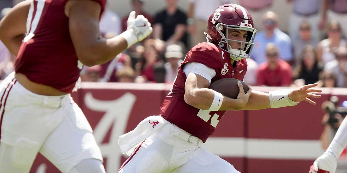 Alabama quarterback Ty Simpson (15) runs the ball against Wisconsin at Saban Field at Bryant-Denny Stadium.