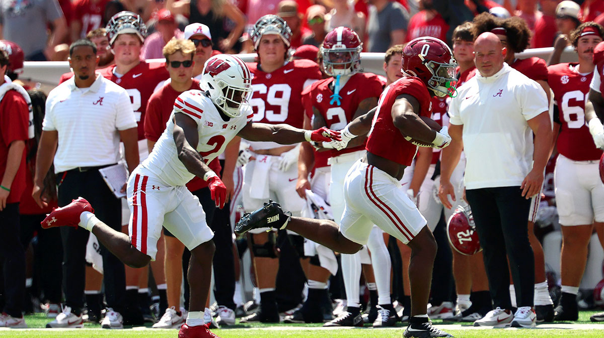 Sep 13, 2025; Tuscaloosa, Alabama, USA; Alabama Crimson Tide running back AK Dear (0) is pushed out of bounds by Wisconsin Badgers cornerback Ricardo Hallman (2) during the second half at Saban Field at Bryant-Denny Stadium. Mandatory Credit: David Leong-Imagn Images