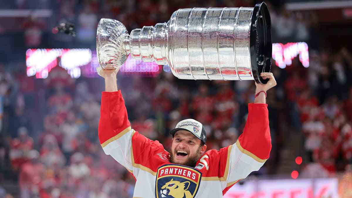 Florida Panthers center Aleksander Barkov (16) hoists the Stanley Cup after winning game six of the 2025 Stanley Cup Final against the Edmonton Oilers at Amerant Bank Arena.