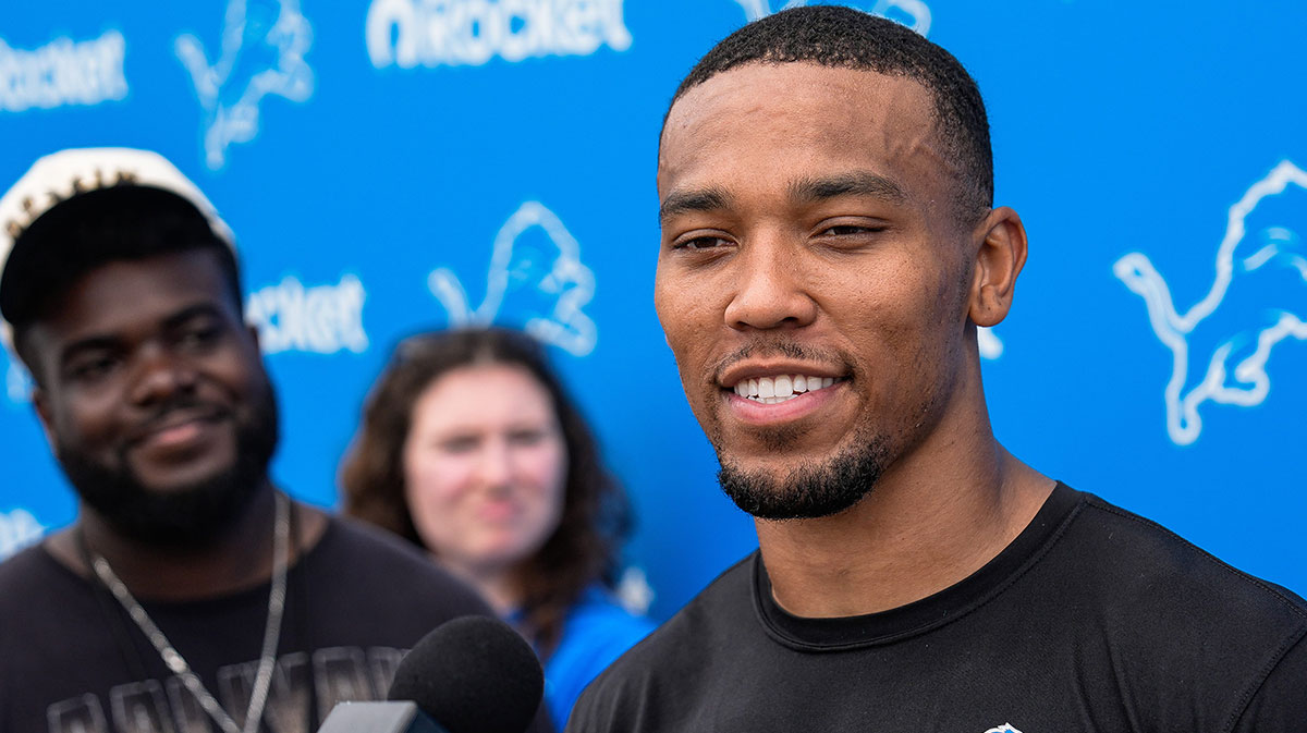 Detroit Lions wide receiver Amon-Ra St. Brown (14) answers a question after practice during training camp