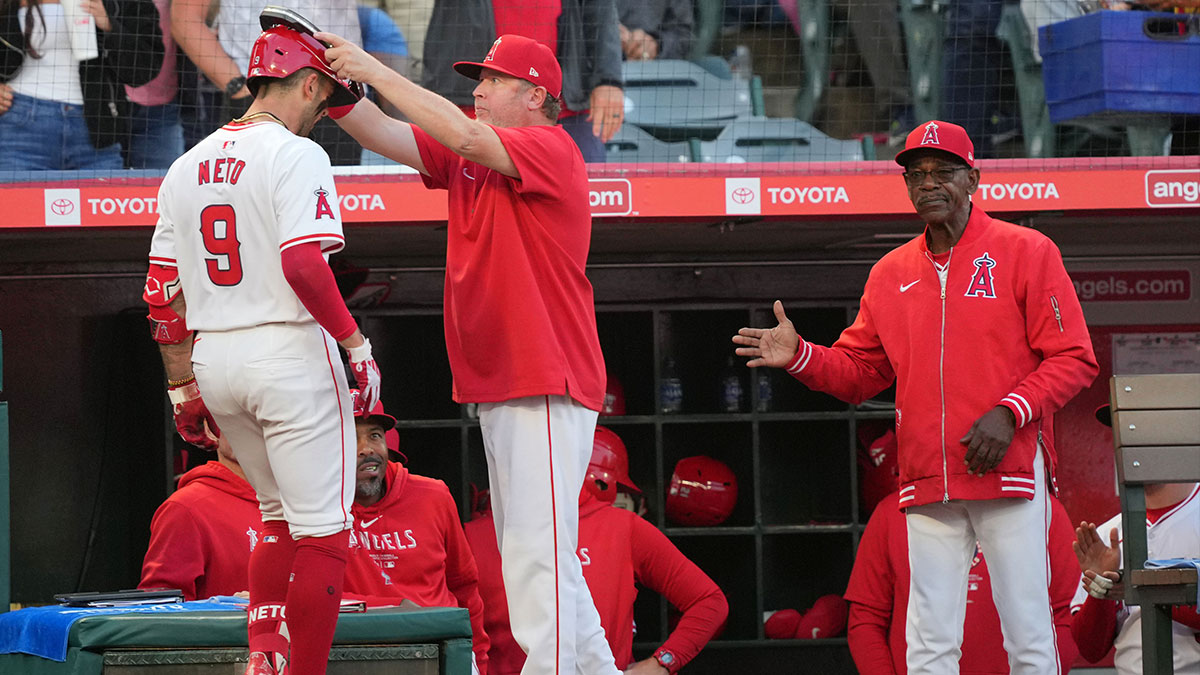 Los Angeles Angels shortstop Zach Neto (9) is congratulated by bench coach Ray Montgomery (81) and manager Ron Washington after hitting a two-run home run in the fourth inning against the Milwaukee Brewers at Angel Stadium.