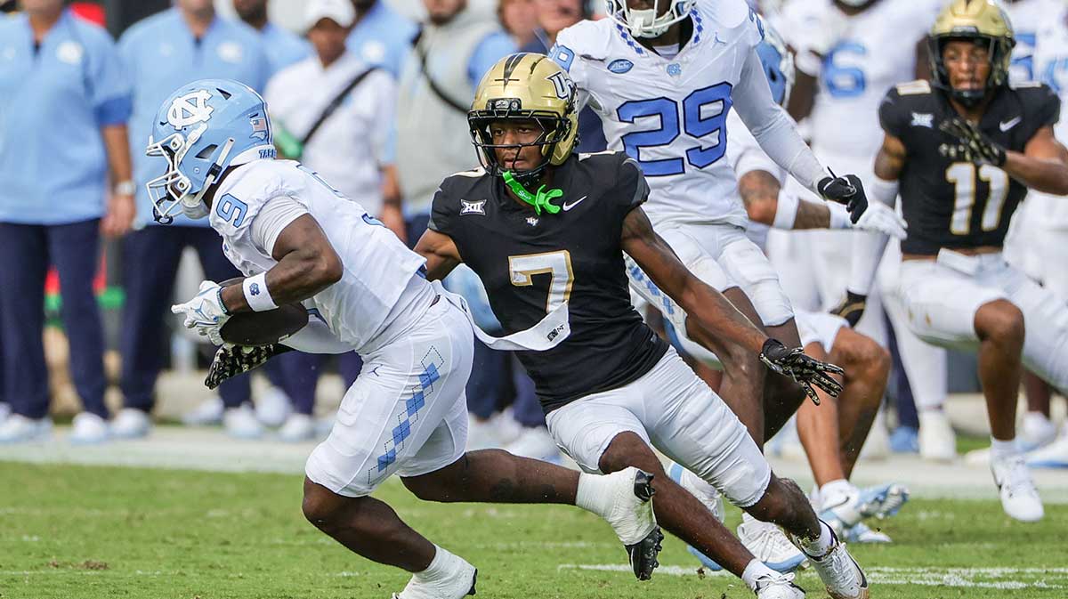 North Carolina Tar Heels wide receiver Javarius Green (9) runs the ball as UCF Knights defensive back Antione Jackson (7) moves in for the tackle during the second quarter at the Bounce House Stadium.