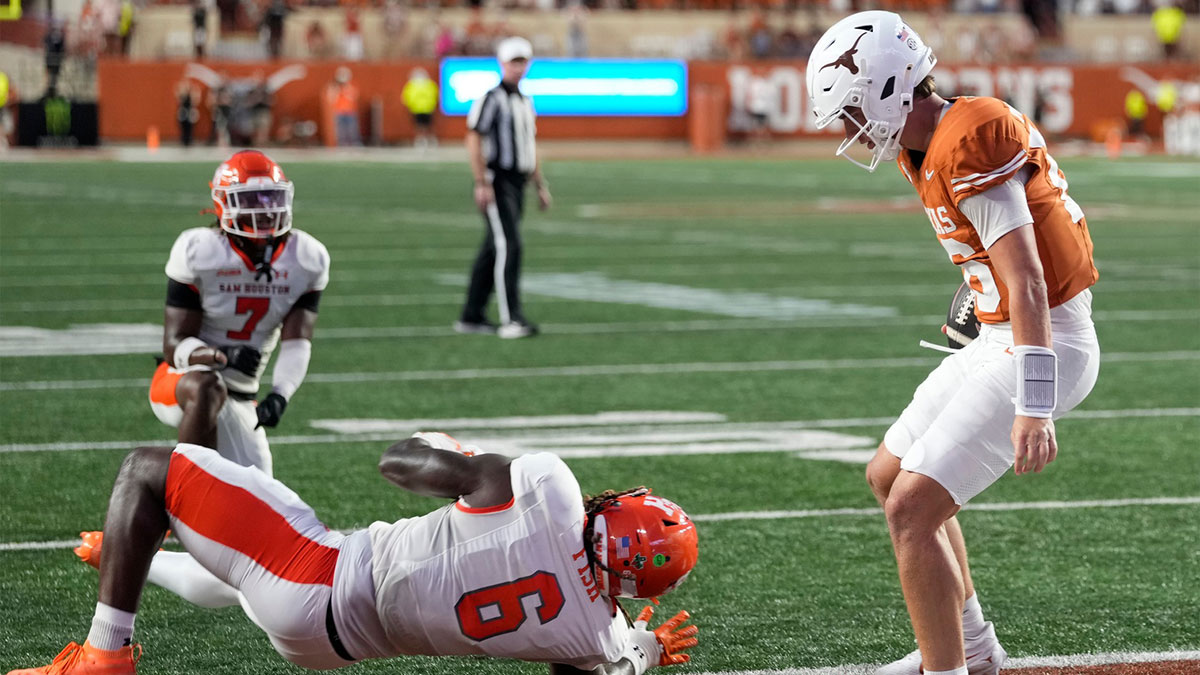 Texas Longhorns quarterback Arch Manning (16) runs in for a touchdown past Sam Houston Bearkats linebacker Antivirus Fish (6) during the first half at Darrell K Royal-Texas Memorial Stadium.