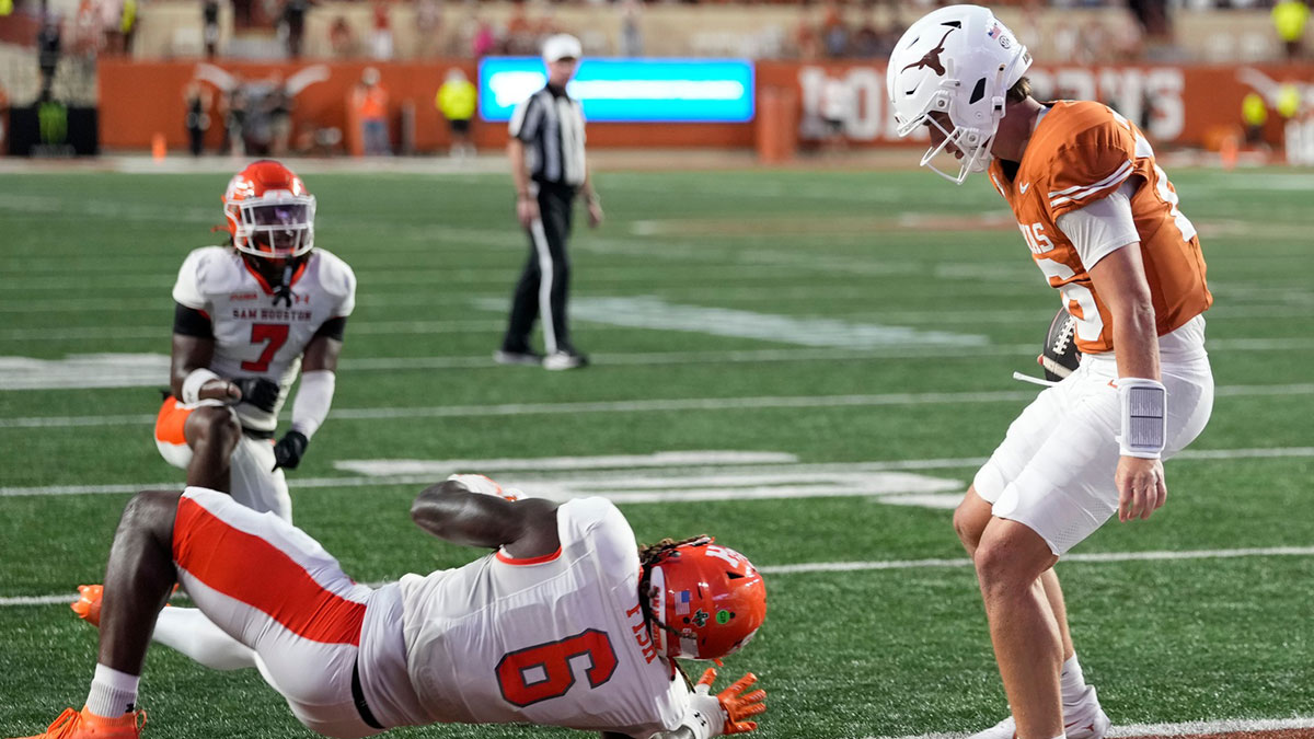 Texas Longhorns quarterback Arch Manning (16) runs in for a touchdown past Sam Houston Bearkats linebacker Antivirus Fish (6) during the first half at Darrell K Royal-Texas Memorial Stadium.